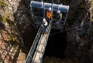 A person in standing in the elevator that descends into the dormant volcano of Thrihnukagigur.