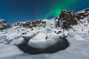 Snow-covered Oxararfoss Waterfall in Thingvellir National Park, a scenic highlight of Iceland’s Golden Circle and a key site along the Mid-Atlantic Rift.
