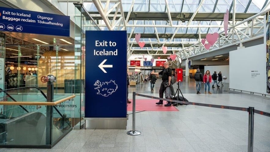 The blue exit to Iceland sign for arrivals to Keflavik International Airport in Iceland
